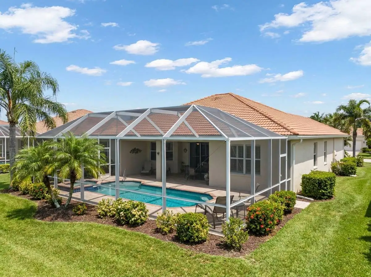 Freshly repainted modern pool screen enclosure in bright South Florida daylight