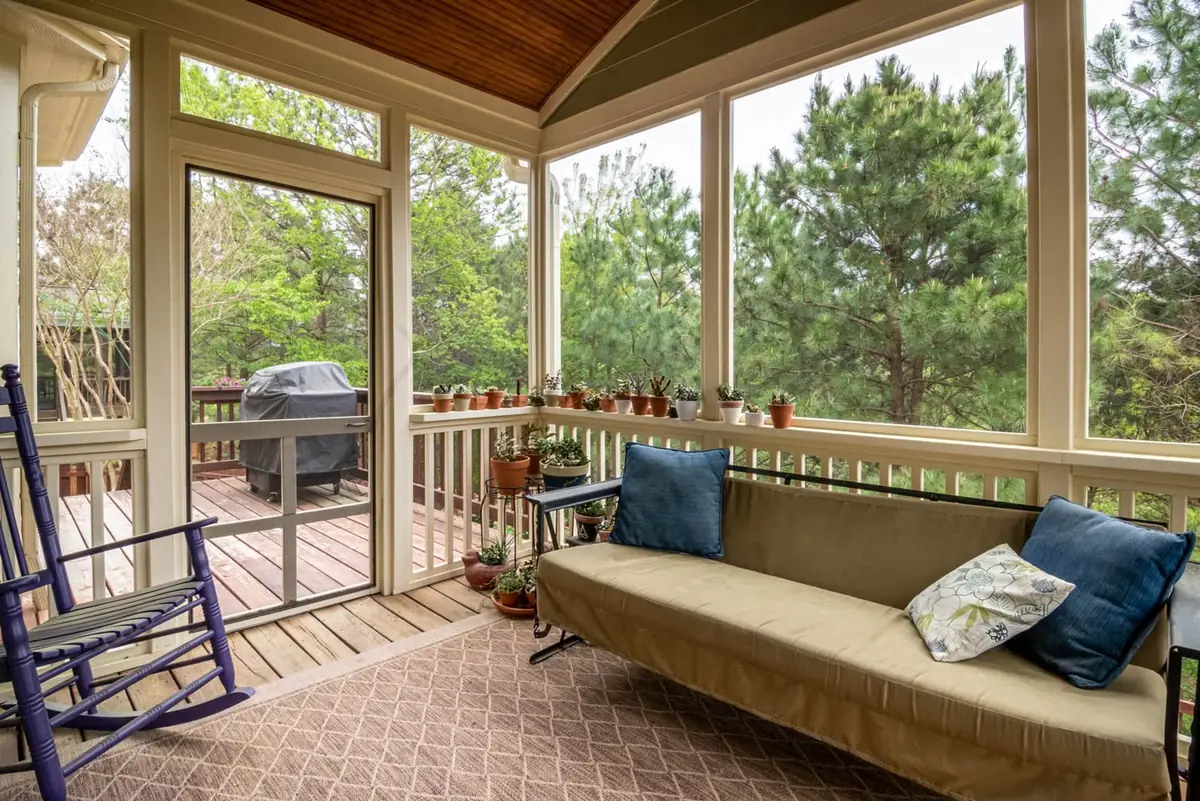Furnished screened porch living space protected by intact screen mesh