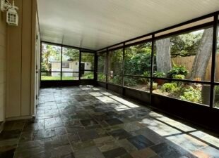Screen porch with a newly painted dark bronze aluminum frame, new screens and a slate tile floor